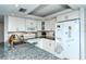 Bright kitchen with white cabinets, stainless steel appliances, and stylish backsplash at 6415 Midnight Pass Rd # 607, Sarasota, FL 34242
