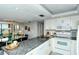 Modern kitchen featuring granite countertops, stainless steel appliances, and an open floor plan at 6415 Midnight Pass Rd # 607, Sarasota, FL 34242
