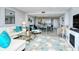 Bright living room with tile floors, fireplace, stylish furniture, and view of the dining area at 6415 Midnight Pass Rd # 607, Sarasota, FL 34242