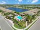 Aerial view showcases the pool and landscaped common areas nestled within a lakeside community at 6492 Positano Ct, Sarasota, FL 34243