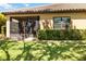 Backyard with a screened in lanai, a lush lawn, trimmed hedges, and a tiled roof at 6492 Positano Ct, Sarasota, FL 34243