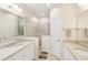 Luxurious bathroom with dual sinks, a glass-enclosed shower, and neutral tile, provides a spa-like retreat at 6492 Positano Ct, Sarasota, FL 34243