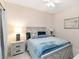 Comfortable bedroom features stylish furnishings and blue decorative pillows, creating a cozy and inviting atmosphere at 6492 Positano Ct, Sarasota, FL 34243