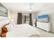 Bedroom features a large TV, offering entertainment, alongside neutral tones for a peaceful vibe at 6492 Positano Ct, Sarasota, FL 34243