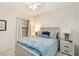 A well-lit bedroom has neutral decor, a white wood bed frame, and matching nightstands, providing a calming retreat at 6492 Positano Ct, Sarasota, FL 34243