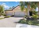 Charming home featuring a three-car garage, a tiled roof, and professional landscaping at 6492 Positano Ct, Sarasota, FL 34243