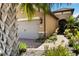 Exterior view of a charming single-story home with neutral stucco and well-maintained landscaping at 6492 Positano Ct, Sarasota, FL 34243