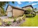 Side view of a charming single-story home with neutral stucco and well-maintained landscaping at 6492 Positano Ct, Sarasota, FL 34243