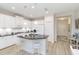 The kitchen features white cabinetry, a black countertop island with seating, and modern appliances at 6492 Positano Ct, Sarasota, FL 34243