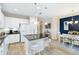Modern kitchen with white cabinets, granite countertops, stainless steel appliances, and a breakfast bar at 6492 Positano Ct, Sarasota, FL 34243