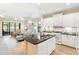 Modern kitchen featuring an island, white cabinets, and a view into the open-concept living space at 6492 Positano Ct, Sarasota, FL 34243