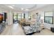 The living room features a neutral color palette, wood flooring, and sliding glass doors to the outdoors at 6492 Positano Ct, Sarasota, FL 34243