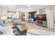 Open-concept living space with a dining area and kitchen featuring wood floors and light walls at 6492 Positano Ct, Sarasota, FL 34243