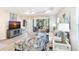 Well-lit living room featuring a sliding glass door, modern furniture, and wood floors at 6492 Positano Ct, Sarasota, FL 34243