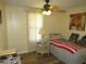 Bedroom with wood-look floors, a cozy single bed, and warm natural light at 705 Blackburn Blvd, North Port, FL 34287