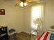 Small bedroom offering ample natural light and simple furnishings at 705 Blackburn Blvd, North Port, FL 34287