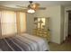 Bright bedroom featuring a ceiling fan, large window, and a classic dresser at 705 Blackburn Blvd, North Port, FL 34287