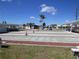 Fun in the sun playing bocce ball surrounded by beautiful landscaping and clear blue skies at 705 Blackburn Blvd, North Port, FL 34287