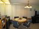 Cozy dining area with a round table, comfortable chairs, and soft lighting at 705 Blackburn Blvd, North Port, FL 34287