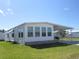Well-maintained home featuring a lush green lawn and a convenient carport for parking at 705 Blackburn Blvd, North Port, FL 34287