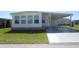 Charming single-story home featuring a covered parking area, well-maintained lawn, and traditional architecture at 705 Blackburn Blvd, North Port, FL 34287