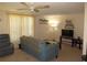 Inviting living room with a ceiling fan, comfortable seating, and neutral decor at 705 Blackburn Blvd, North Port, FL 34287