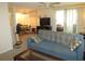 Bright living room featuring comfortable seating, TV, and an attached dining space for entertaining at 705 Blackburn Blvd, North Port, FL 34287