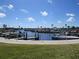 Picturesque marina featuring clear blue water, boats, and scenic palm trees in the background at 705 Blackburn Blvd, North Port, FL 34287