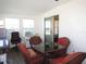 Bright sunroom with a table and chairs and access to the outdoors via sliding doors at 705 Blackburn Blvd, North Port, FL 34287