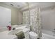 Well lit bathroom with a tub shower, a vanity with a white countertop, and neutral colored walls at 7205 Wood Creek Dr # 16, Sarasota, FL 34231