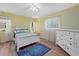 Cozy bedroom featuring wood floors, bright yellow walls and abundant natural light at 7205 Wood Creek Dr # 16, Sarasota, FL 34231