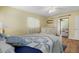 Comfortable bedroom featuring wood floors, yellow walls and abundant natural light at 7205 Wood Creek Dr # 16, Sarasota, FL 34231