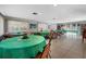 Large common room with tables, chairs, books, and decorations, creating a versatile and inviting space at 7205 Wood Creek Dr # 16, Sarasota, FL 34231