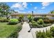Charming single story home with a landscaped yard and walkway to the front door at 7205 Wood Creek Dr # 16, Sarasota, FL 34231