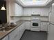 Kitchen with white cabinets, gray countertops, and stainless-steel appliances at 7205 Wood Creek Dr # 16, Sarasota, FL 34231