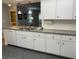 Updated kitchen boasts white cabinets and gray countertops at 7205 Wood Creek Dr # 16, Sarasota, FL 34231