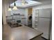 Bright kitchen features white cabinets, neutral countertops, and modern appliances at 7205 Wood Creek Dr # 16, Sarasota, FL 34231