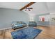 Bright living room open to the kitchen with hardwood floors, and vaulted ceiling with exposed beam at 7205 Wood Creek Dr # 16, Sarasota, FL 34231