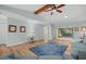 Living room with wood floors, blue rug and furniture, vaulted ceiling, and beam detail at 7205 Wood Creek Dr # 16, Sarasota, FL 34231