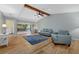 Open living room with vaulted ceilings, wood beams, and sliding glass doors to the lanai at 7205 Wood Creek Dr # 16, Sarasota, FL 34231