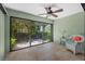 Bright sun room with tile floors and large sliding glass doors to the backyard at 7205 Wood Creek Dr # 16, Sarasota, FL 34231