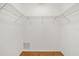 Empty walk-in closet with wire shelving and hardwood floors providing ample storage at 7205 Wood Creek Dr # 16, Sarasota, FL 34231
