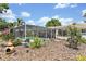 Enjoy the screen enclosed pool surrounded by tropical landscaping and a beautiful bird bath at 7542 Swanson Ln, Sarasota, FL 34231