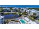 Aerial view of a waterfront property featuring white buildings, a pond, a pool, and lush landscaping at 7810 34Th W Ave # 103, Bradenton, FL 34209