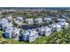 An aerial of a community showcases manicured lawns, lush landscaping and a view of the community ponds at 7810 34Th W Ave # 103, Bradenton, FL 34209