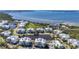 Aerial view of a gated community showcases condominiums, a tranquil pond, and manicured landscaping at 7810 34Th W Ave # 103, Bradenton, FL 34209
