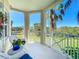 View from this home's balcony with white wicker seating and lush views of the surrounding property at 7810 34Th W Ave # 103, Bradenton, FL 34209