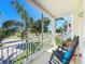 Relaxing balcony featuring a rocking chair with water views and tropical landscaping at 7810 34Th W Ave # 103, Bradenton, FL 34209