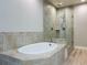 Primary bathroom with a luxurious soaking tub and a separate glass-enclosed shower at 7810 34Th W Ave # 103, Bradenton, FL 34209