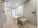 Bathroom featuring soaking tub, shower and walk-in closet with wire shelving at 7810 34Th W Ave # 103, Bradenton, FL 34209